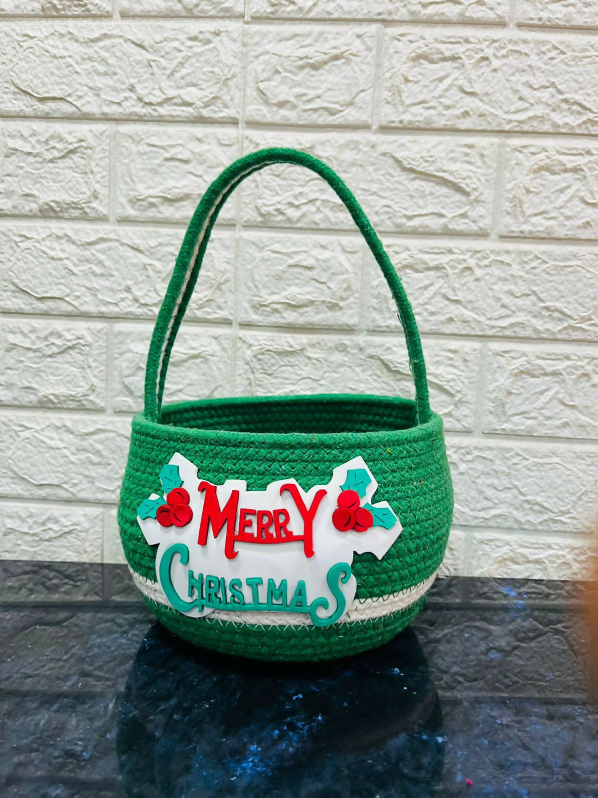 Green Christmas-themed basket with 'Merry Christmas'