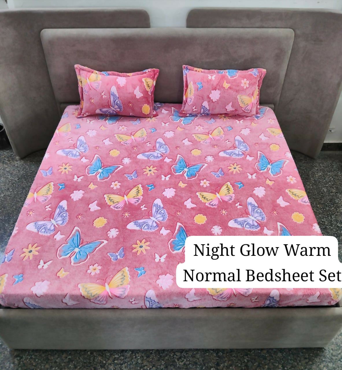 Pink butterfly-patterned bedsheet set on a bed