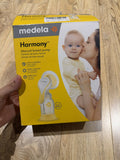 Medela Harmony Manual Single Hand Breast Pump with Flex™ Shields, ergonomic one-hand operation, soft silicone breast shield, lightweight portable design, and BPA-free components for comfortable milk expression.
