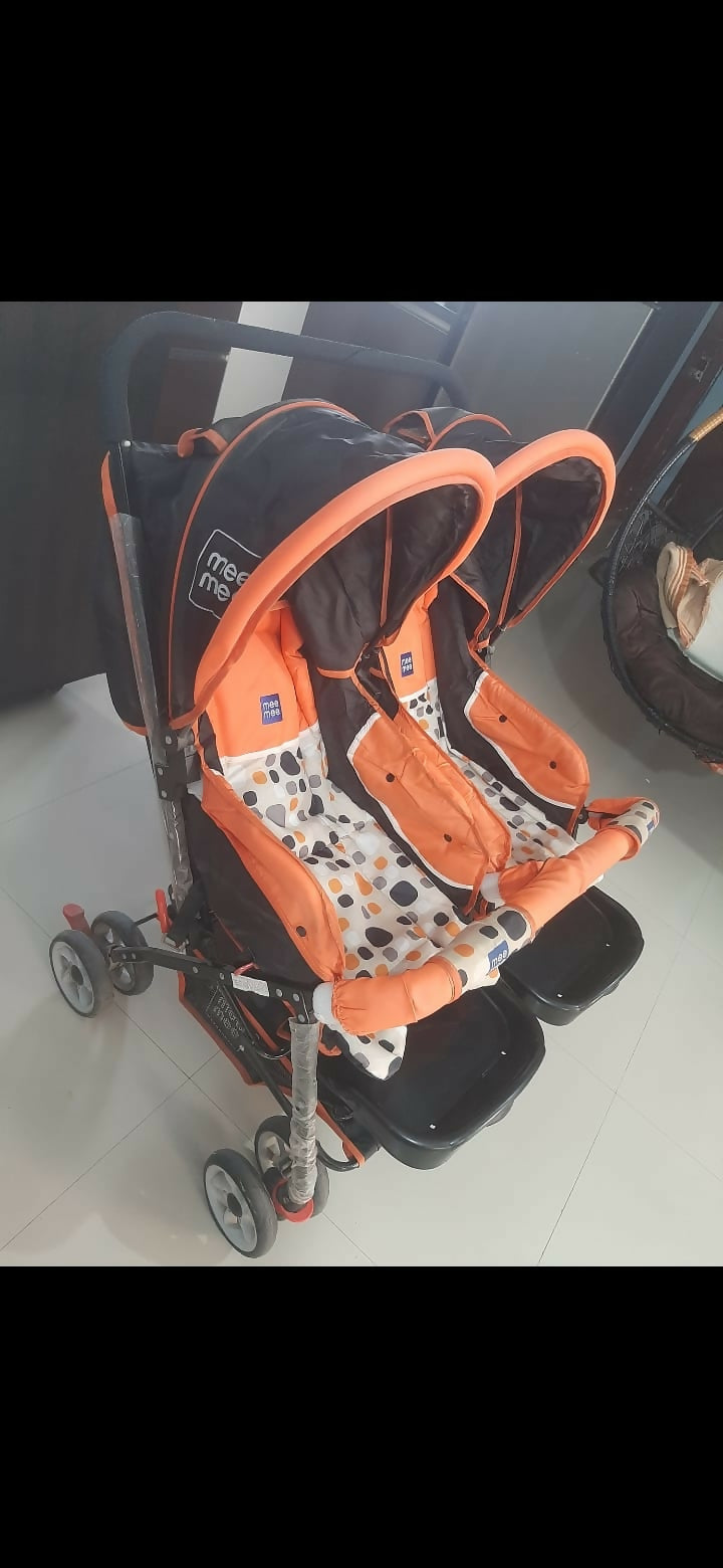 Mee Mee twin stroller pram for babies with dual seating, safety harnesses, smooth wheels, adjustable canopies, and comfortable design for outings with two children.