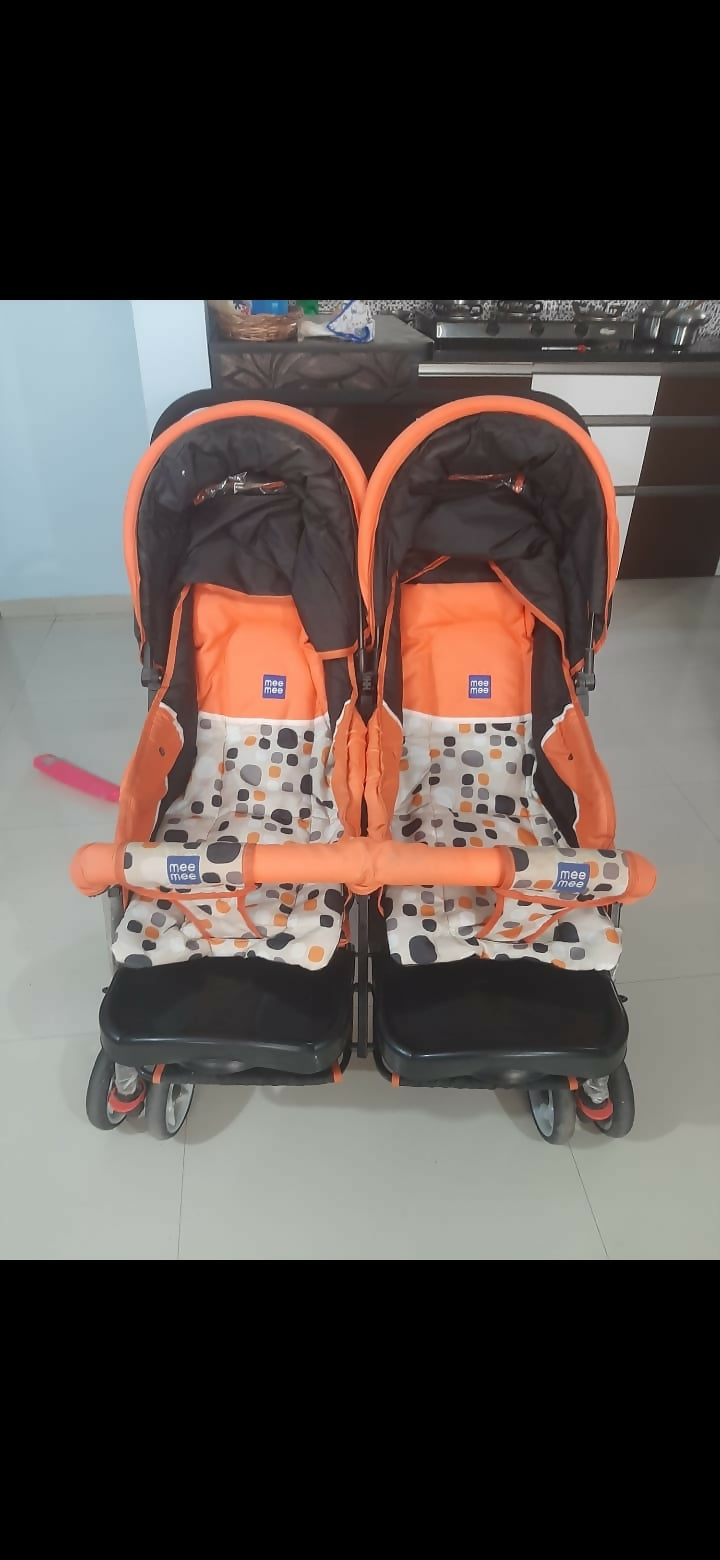 Mee Mee twin stroller pram for babies with dual seating, safety harnesses, smooth wheels, adjustable canopies, and comfortable design for outings with two children.