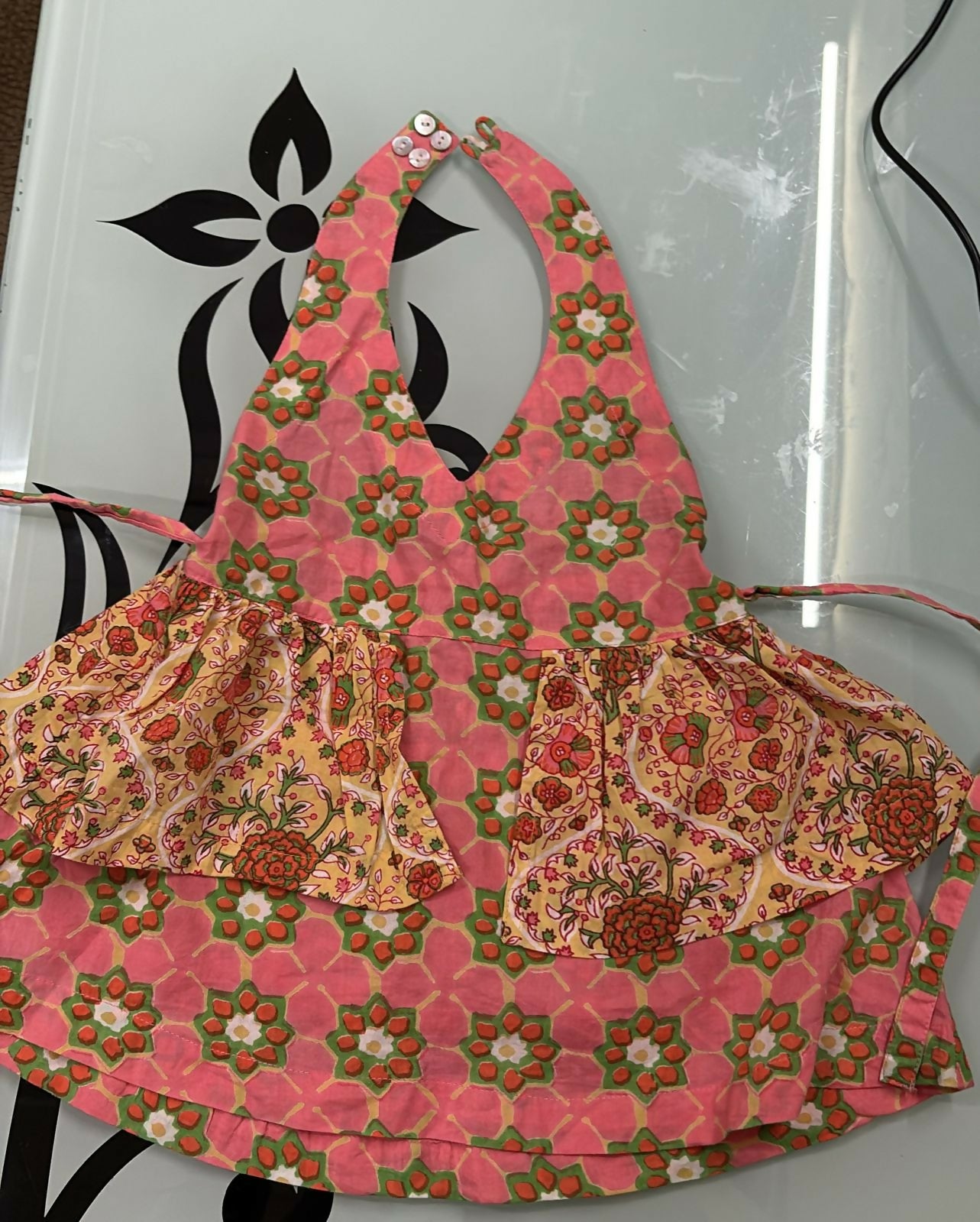 Floral apron with matching pouch on a white background