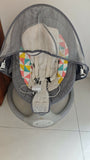 Baby swing with geometric patterned seat cover