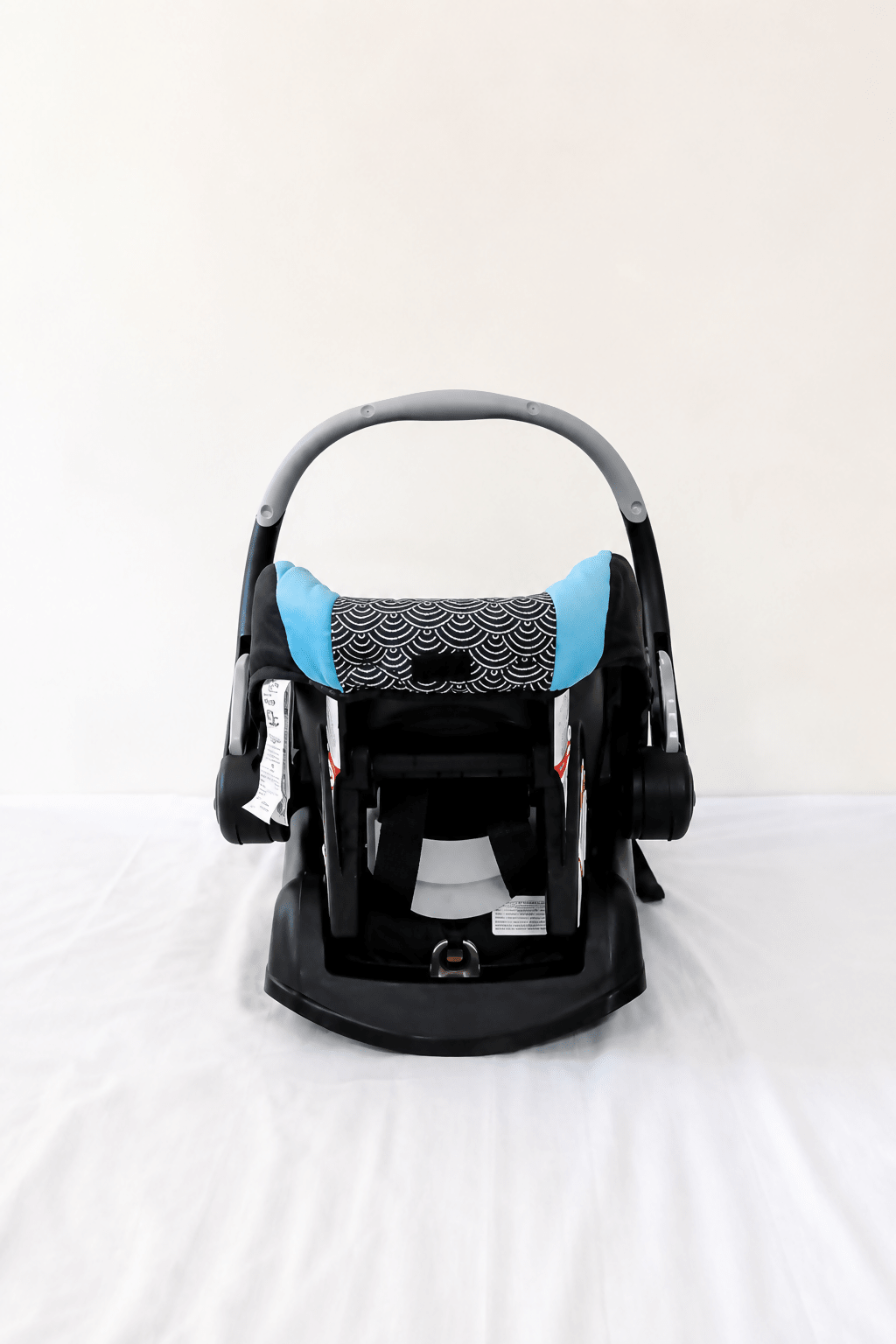 Evenflo Embrace infant car seat with base, rear-facing design, cushioned newborn support, secure safety harness, and portable baby carrier functionality for safe travel.