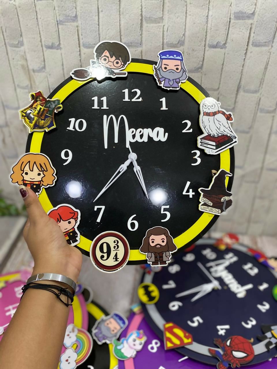 Black clock with cartoon character stickers