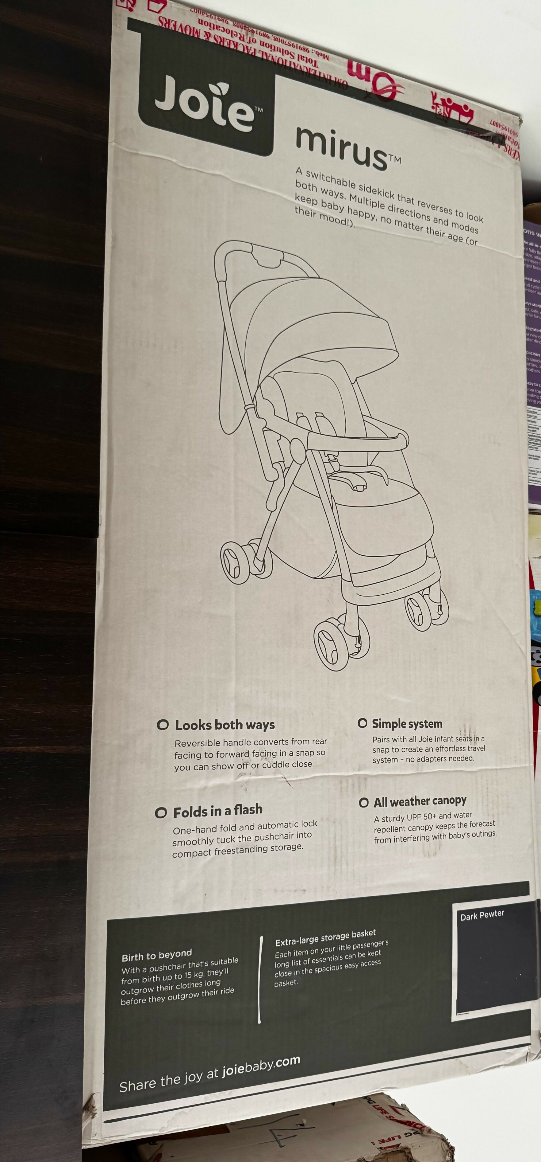 Joie Mirus stroller packaging with illustrations and text on a cardboard box.