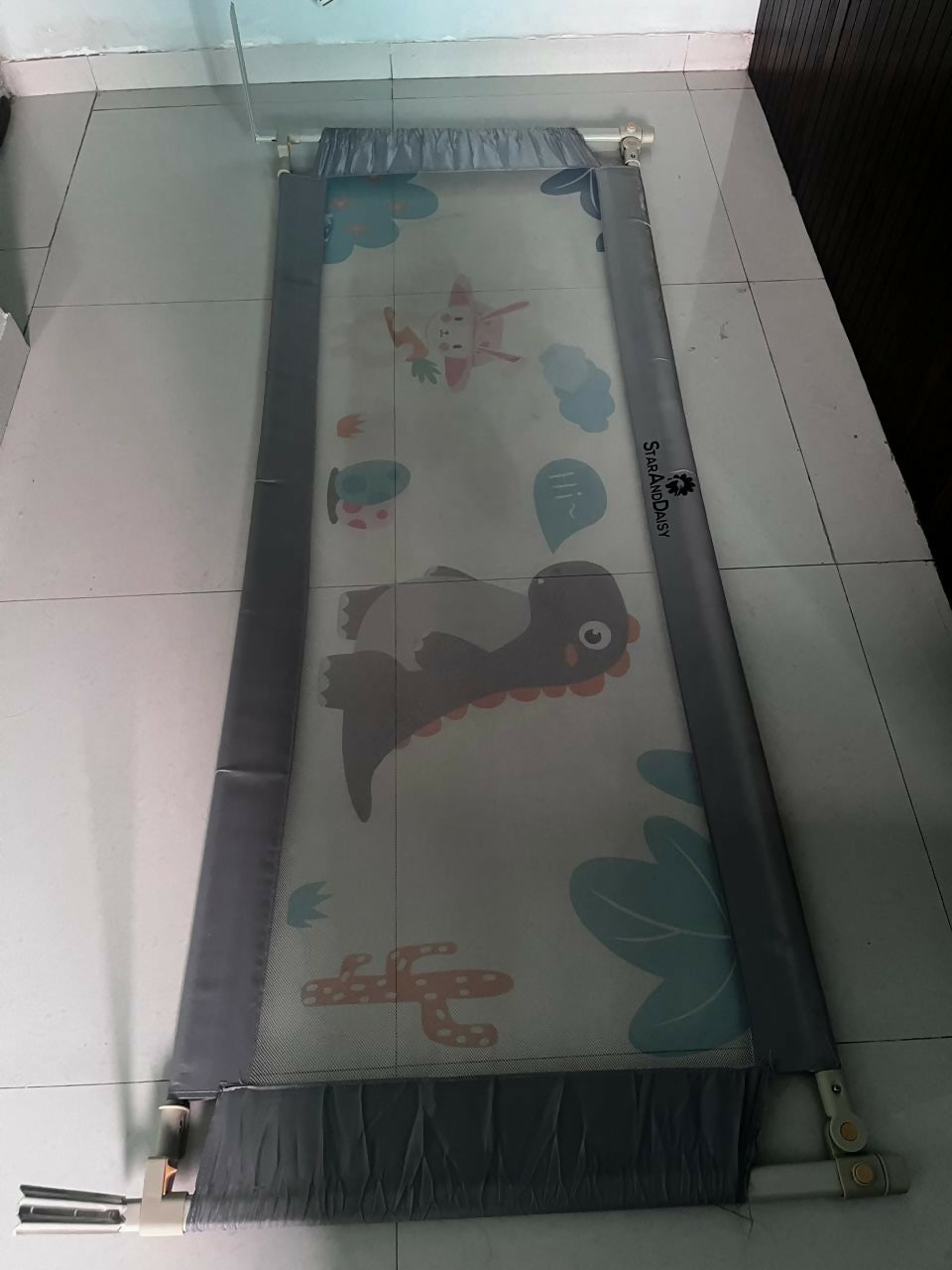 Children's play mat with cartoon designs on a tiled floor