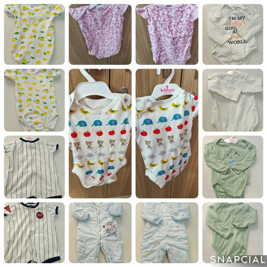 Collage of various baby onesies and clothing items on a wooden surface.
