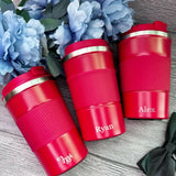 Three red travel mugs with gold lids