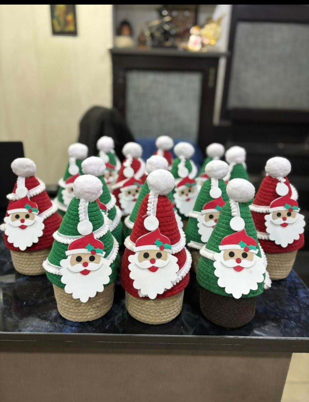 Decorative Christmas bottles with Santa Claus designs on a table.