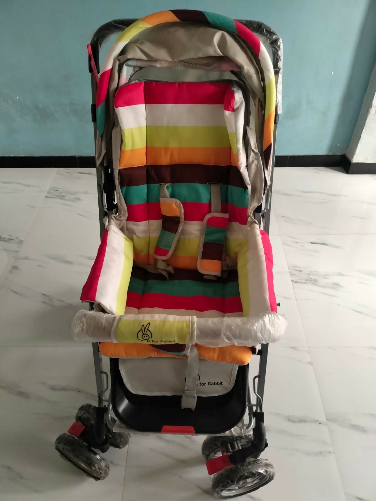 R for Rabbit Lollipop Lite baby stroller/pram with lightweight foldable design, reclining seat, adjustable canopy, 5-point safety harness, smooth wheels, and storage basket for comfortable everyday travel.