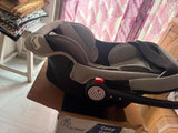 R for Rabbit Cozy Carry Cot/Car Seat with rear-facing design, cushioned seating, ergonomic carry handle, 5-point safety harness, and protective canopy for safe and comfortable travel with newborns and infants.