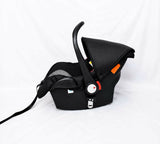 R for Rabbit Picaboo Grand 4 in 1 infant car seat carrier in black and grey with newborn travel cot design, cushioned seat, safety harness, carry handle, and secure support for baby travel.