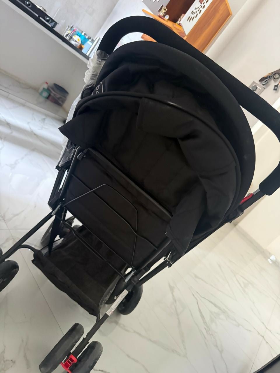BABYHUG Cocoon stroller/pram with a reclining seat, foldable design, adjustable canopy, 5-point safety harness, smooth wheels, and storage basket for comfortable travel with babies and toddlers.