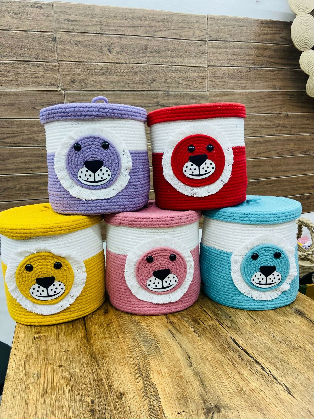 Five colorful woven bear-shaped baskets
