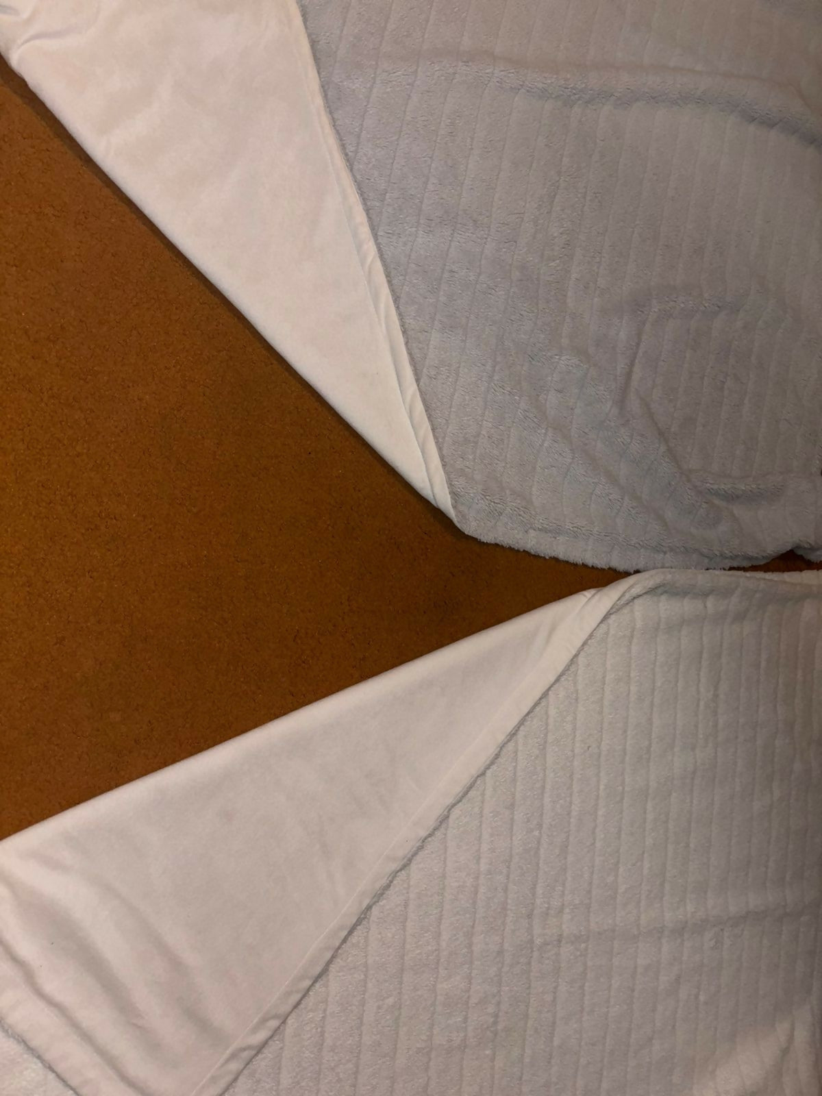 Close-up of a textured fabric with a brown background