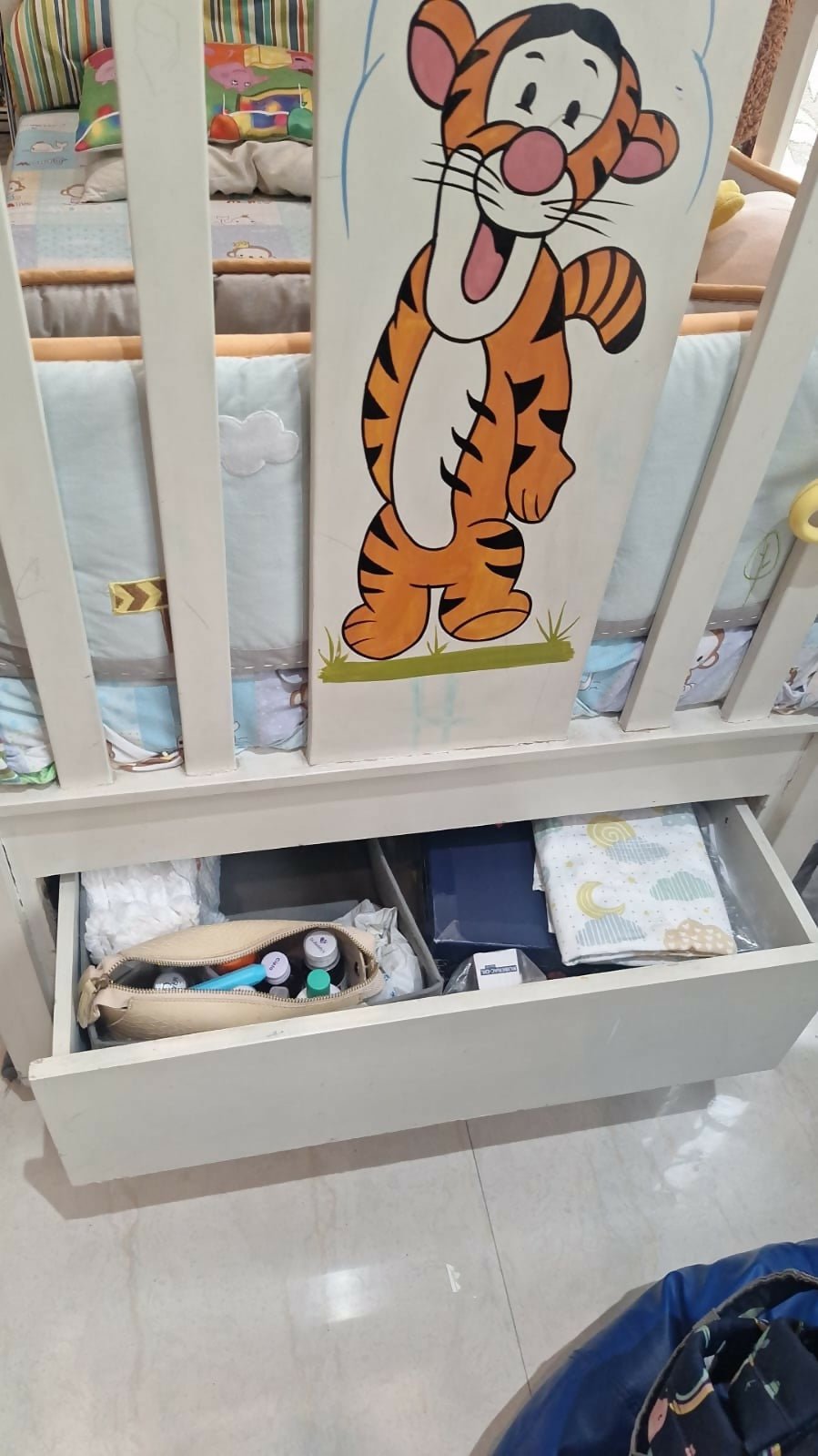 Wooden baby crib with storage, mattress, and bumper featuring sturdy wooden construction, spacious sleeping area, built-in storage, protective bumpers, and comfortable support for babies.