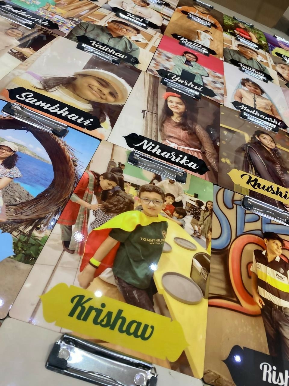 Collection of name cards with various names and images on a table.