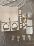 Théa wearable electric breast pump with hands-free design, compact milk collection cups, adjustable suction, and portable pumping support for breastfeeding mothers.