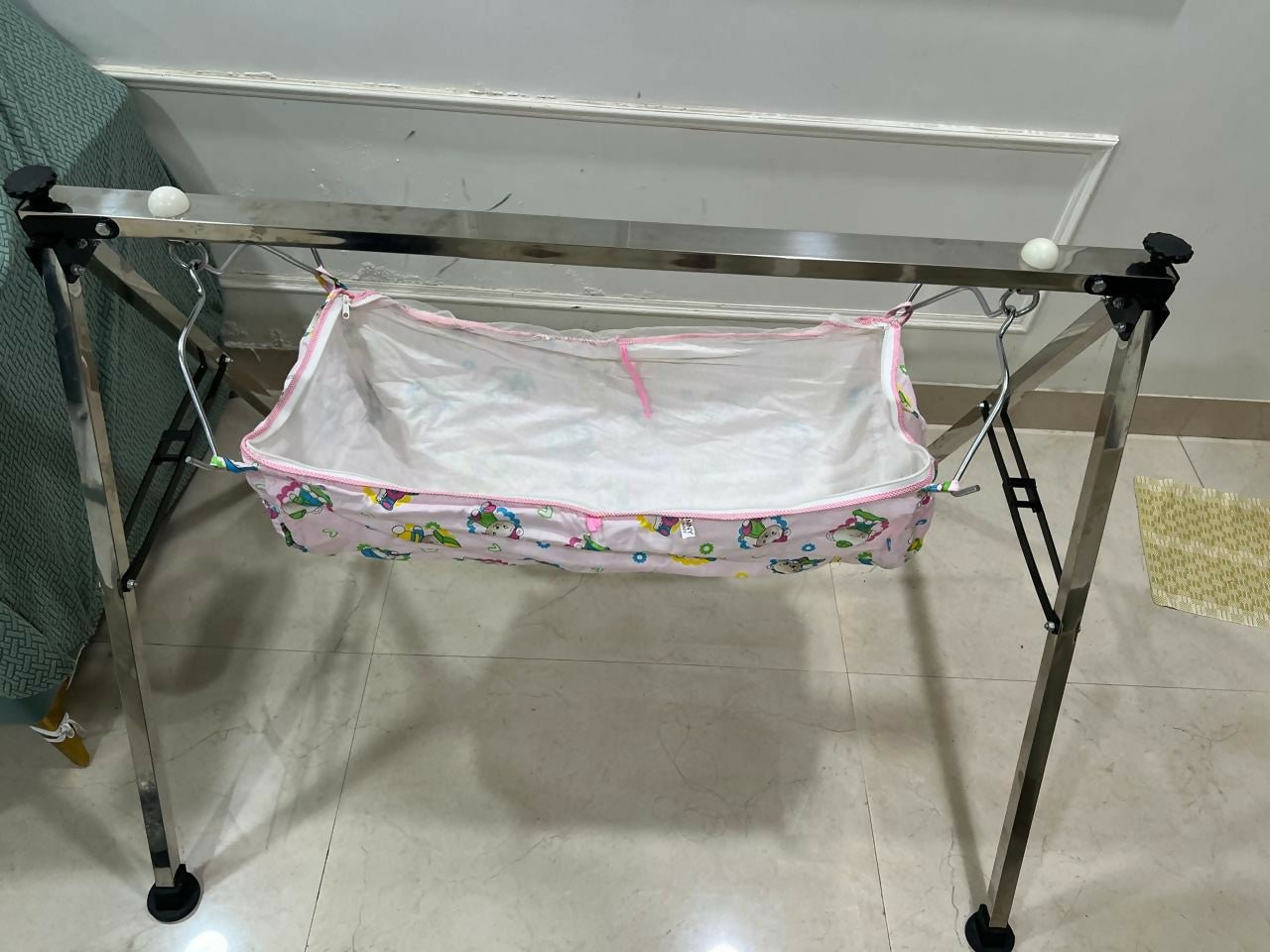 A TO Z HUB portable folding Ghodiyu traditional baby cradle with black cotton cloth, foldable metal frame, gentle rocking design, and a comfortable sleeping space for newborns and infants.