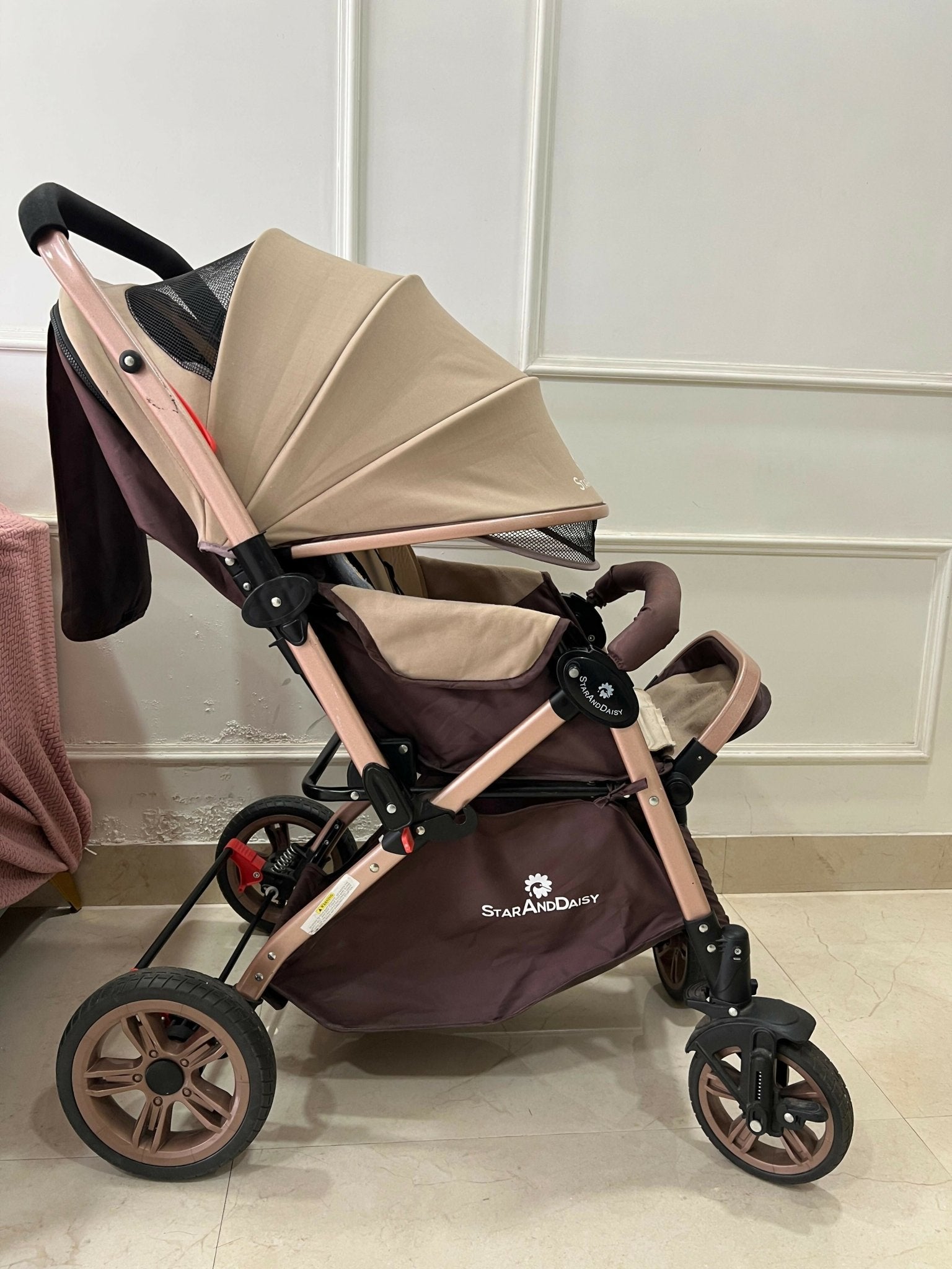 StarAndDaisy foldable baby stroller travel pram with reclining seat, sturdy wheels, safety harness, adjustable canopy, and compact foldable design for comfortable baby travel.