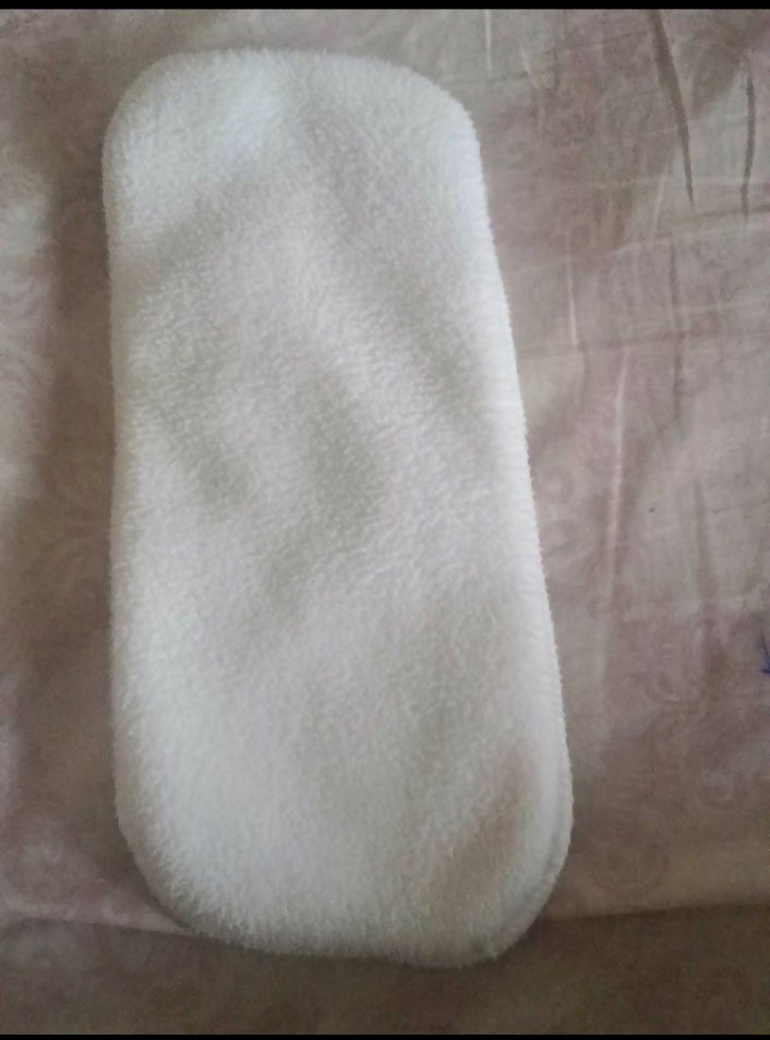 White textured object on a patterned fabric background