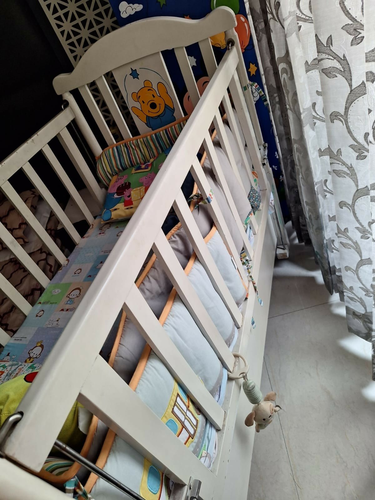 Wooden baby crib with storage, mattress, and bumper featuring sturdy wooden construction, spacious sleeping area, built-in storage, protective bumpers, and comfortable support for babies.
