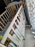 Wooden baby crib with storage, mattress, and bumper featuring sturdy wooden construction, spacious sleeping area, built-in storage, protective bumpers, and comfortable support for babies.