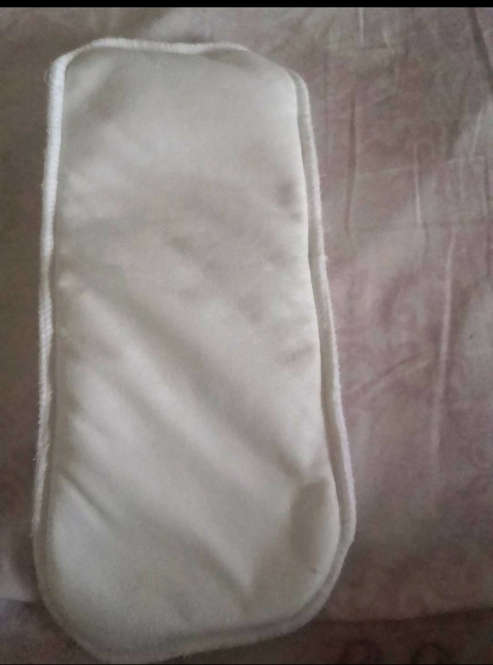 White eye mask on a patterned fabric background