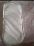 White eye mask on a patterned fabric background