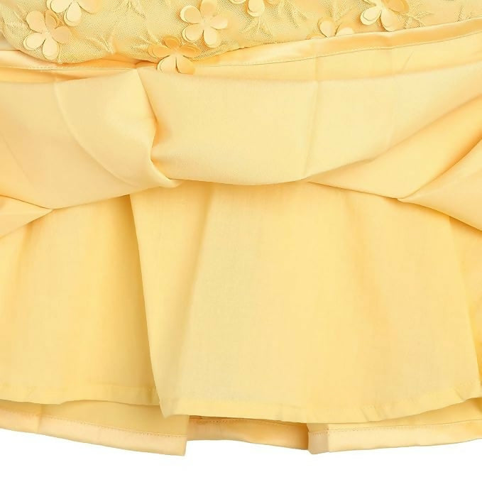 Close-up of a yellow dress with floral embroidery on a white background