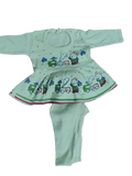 Children's outfit with a green top and pants featuring train designs on a white background