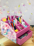 Pink desk organizer with stationery items and a mermaid-themed design
