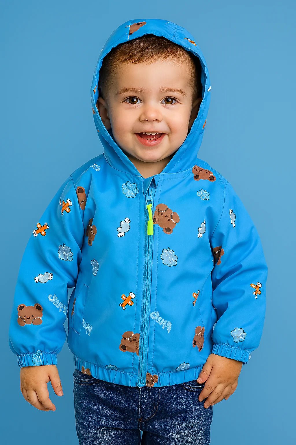 Child wearing a blue jacket with bear prints