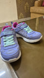 Purple children's sneakers with green laces