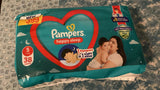 Pampers baby wipes packaging on a textured surface