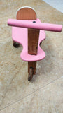 Pink wooden kids balance bike with handlebar and single front wheel, pink, brown