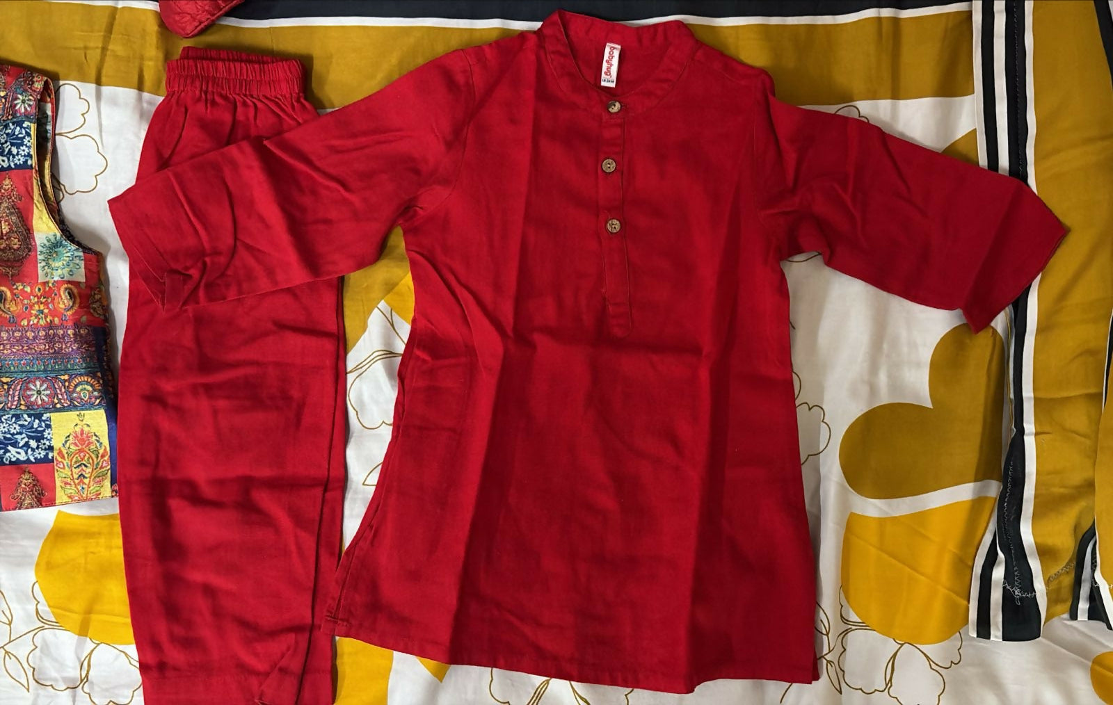 Red pants on a patterned bedspread