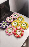 Colorful flower arrangements on a white surface with a black background