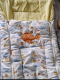 Baby blanket with cartoon fish design on a yellow background