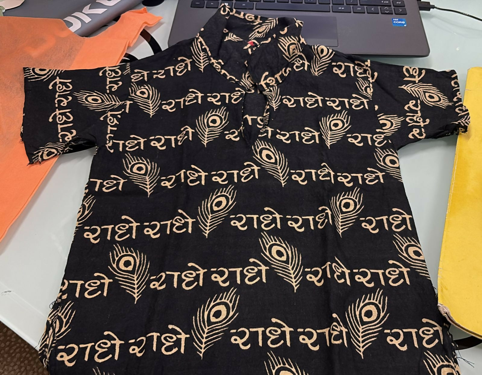 Black dress with gold patterns on a table