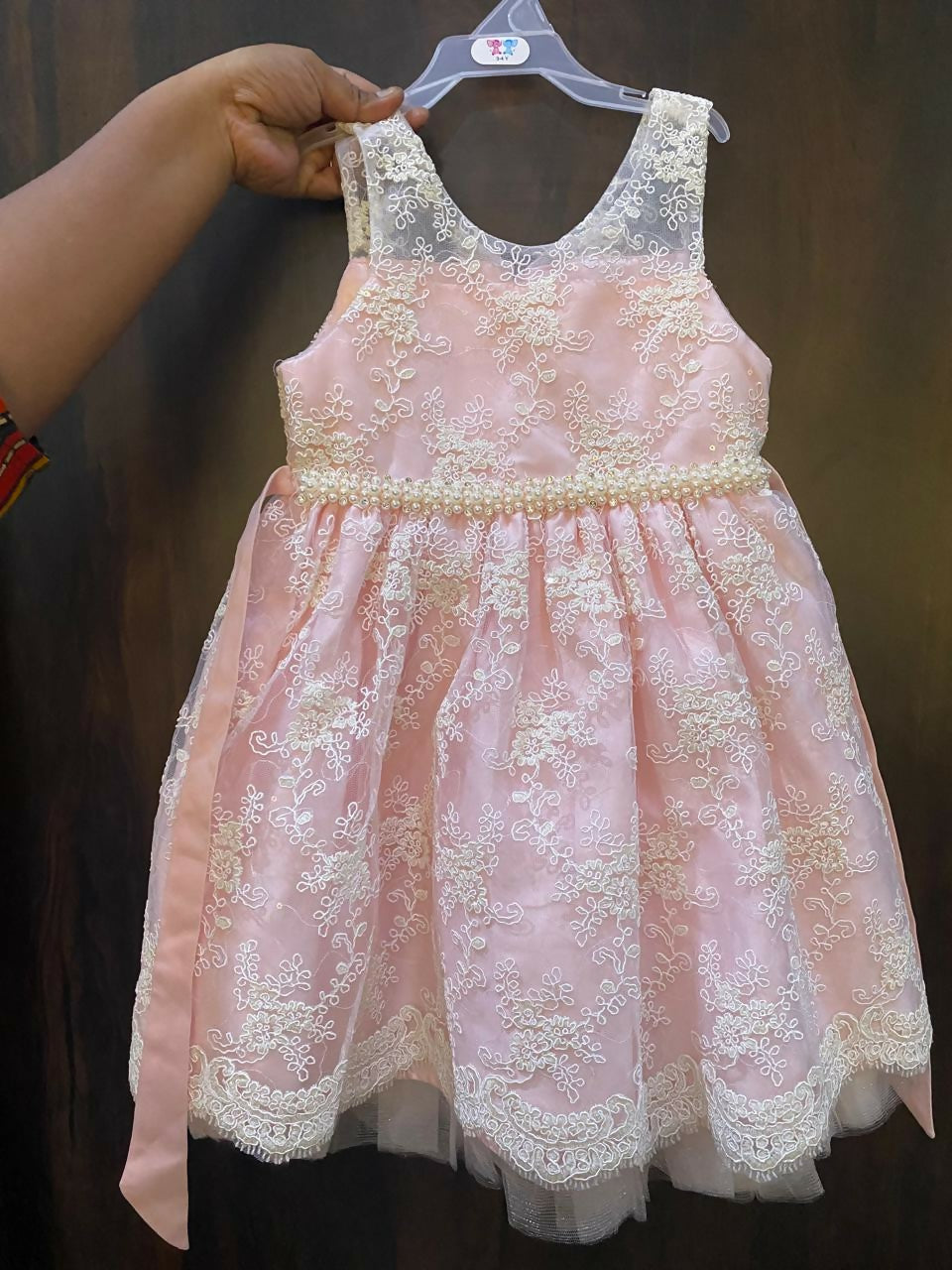 Adorn your baby girl in this elegant Pearl and Lace Work Frock, perfect for making precious memories!