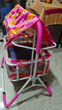 Child's stroller with colorful canopy and pink frame on a plain background