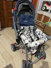 Stroller with a patterned cover on a wooden floor