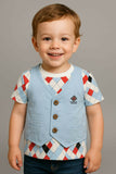 Child wearing a patterned shirt and light blue vest