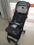 Black baby stroller with colorful design on a tiled floor