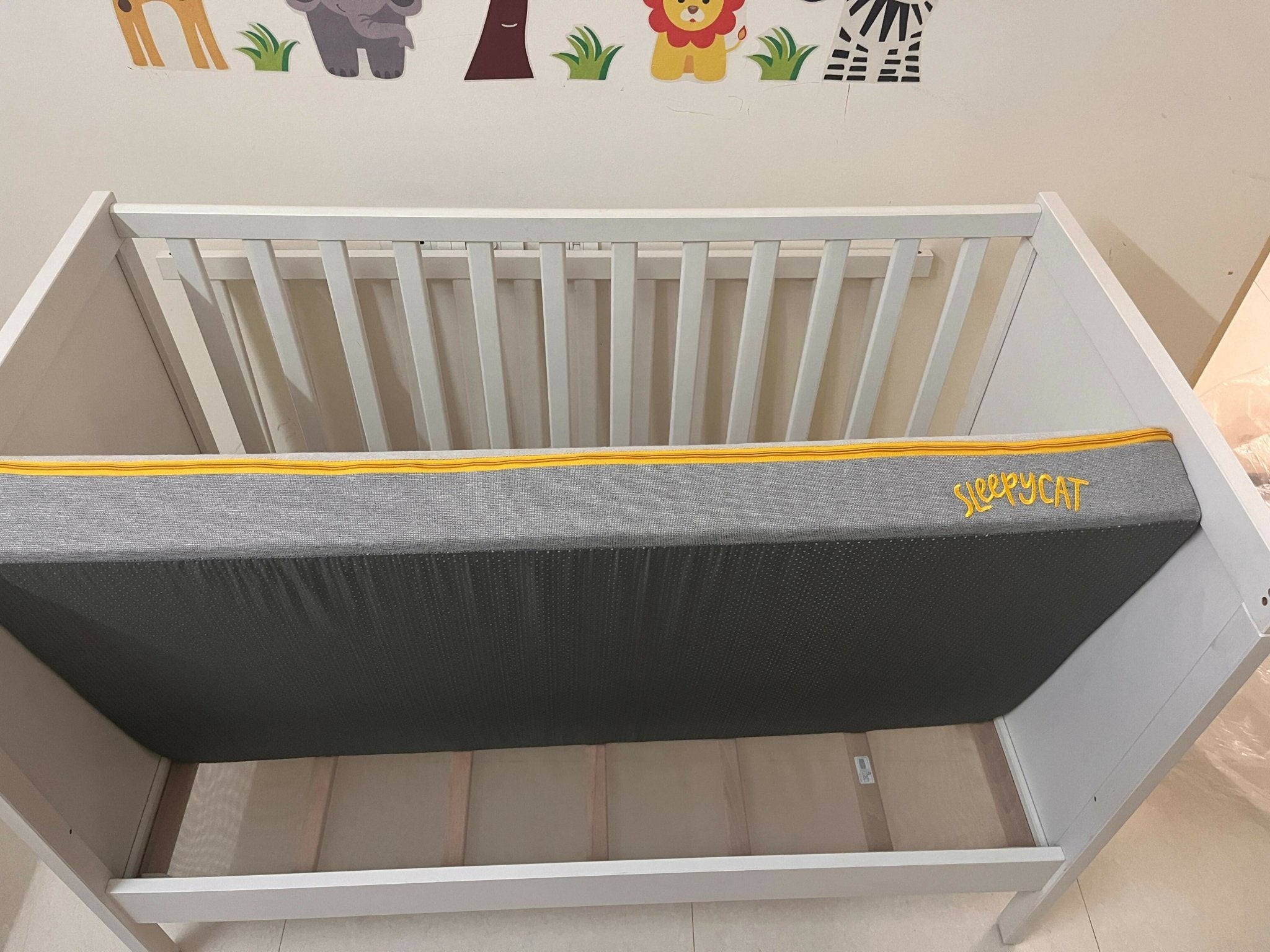 IKEA Sundvik white baby cot with mattress, fitted sheets and cot bumpers, almost new condition, convertible toddler bed design