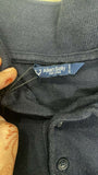 Close-up of a label on a dark-colored garment with 'Allen Solly' branding.
