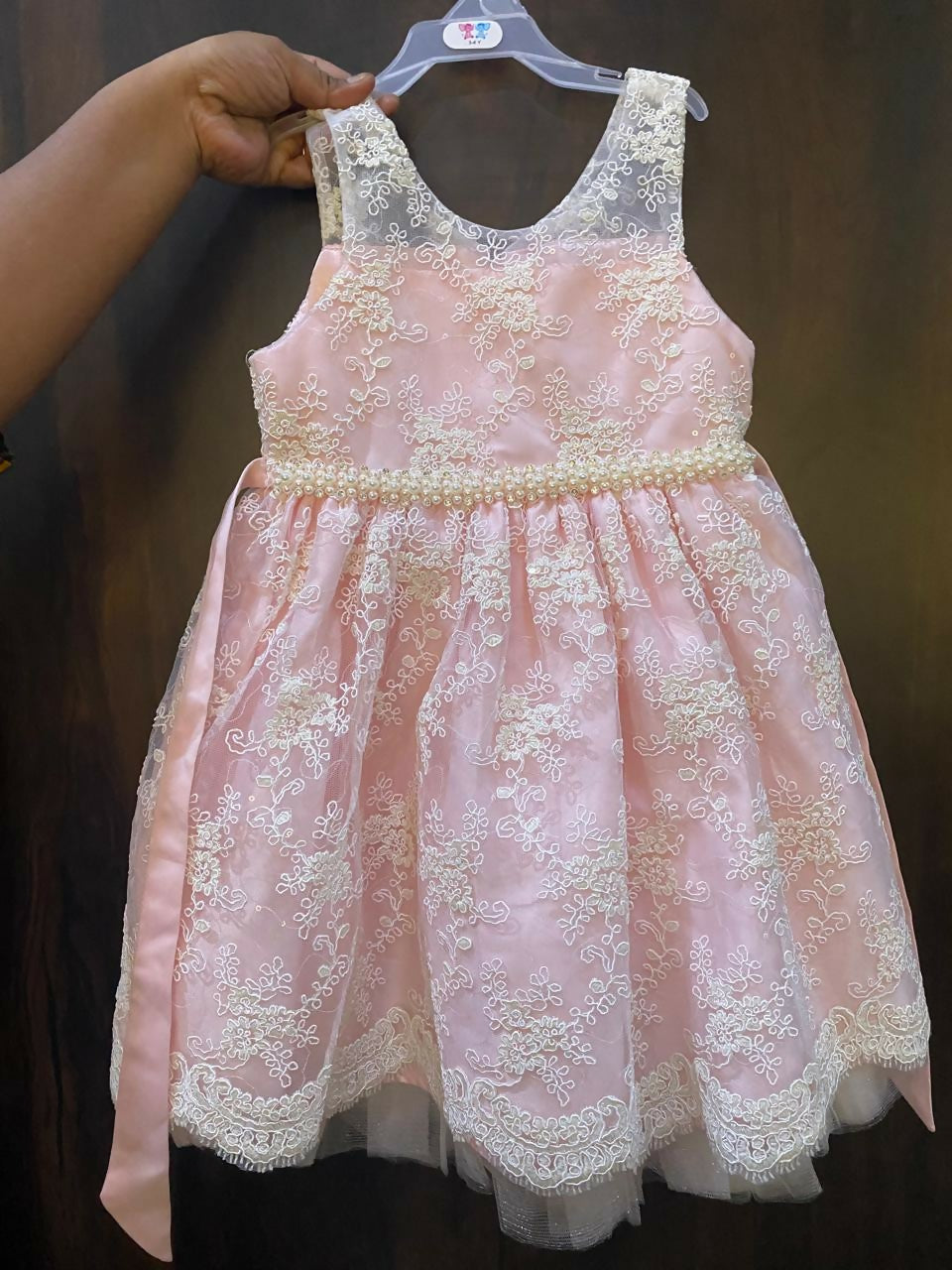 Adorn your baby girl in this elegant Pearl and Lace Work Frock, perfect for making precious memories!