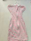 Striped dress on a hanger with 'Milan' label on a textured surface